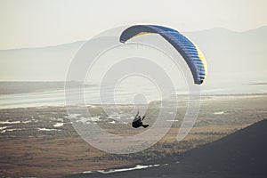Flying paraglider.