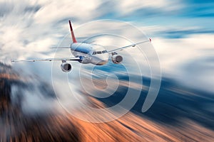 Flying passenger airplane and blurred background