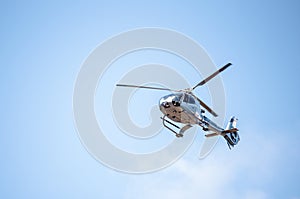Flying passenger helicopter and blue sky