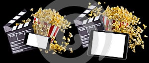 Flying popcorn, film clapper board and phone isolated on black background