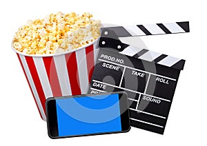 Flying popcorn, film clapper board and phone isolated on white background