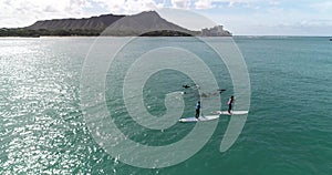 Flying POV, People on SUP next to dolphins off the coast of Bali, Indonesia, in aquamarine water, slow motion _