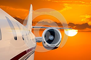 Flying Private Jet Airplane with Sunset background