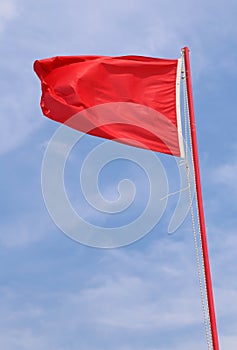 flying red flag indicating a state of danger and alarm