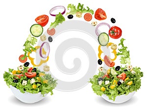 Flying salad ingredients in bowl with tomatoes, onion, olives an