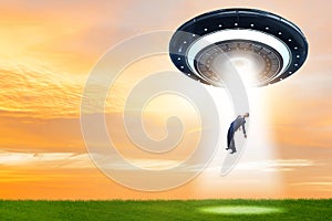 The flying saucer abducting young businessman photo