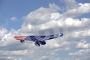 Flying Skateboard with USA flag on a blue sky and clouds