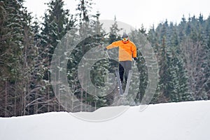 Flying skier at jump from the slope of mountains