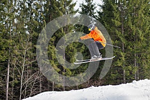 Flying skier man at jump from the slope of mountains