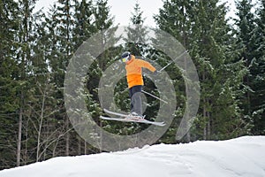 Flying skier man at jump from the slope of mountains