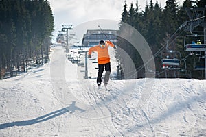 Flying skier man at jump from the slope of mountains