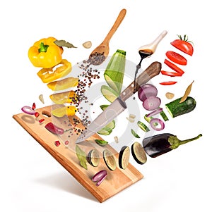 Flying slices of sliced vegetables are served on a wooden board