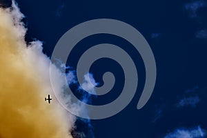 Flying small planie in the navi blue sky