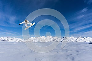 Flying snowboarder on mountains