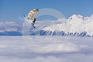 Flying snowboarder on mountains