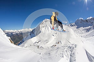 Flying snowboarder on mountains, extreme sport