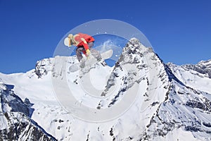 Flying snowboarder on mountains, extreme sport