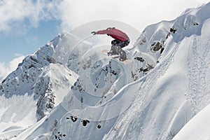 Flying snowboarder on mountains. Extreme winter sport.