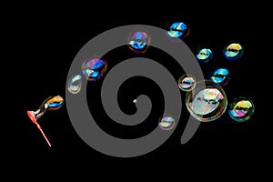 Flying soap bubbles isolated on black background.