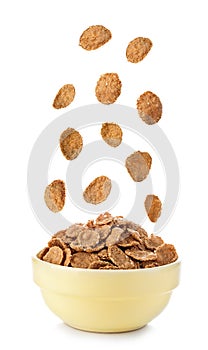 Flying to the bowl cereal flakes isolated on a white background