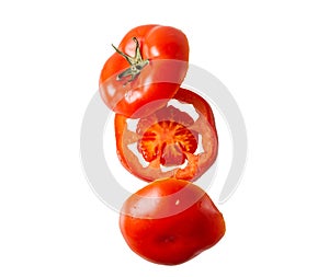 Flying tomato slices on a white background. Levitation of fresh red tomato slices. Isolated