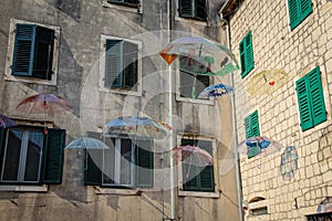 Flying umbrellas in a square in the old town of Kotor, in Montenegro