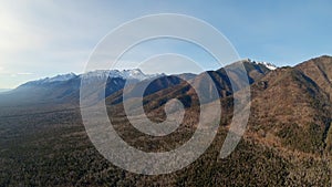 Flying up at the foot of mountains. Aerial view of beautiful mountain landscape