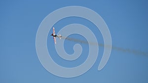 Flying of vintage propeller biplane in air. Winged propeller airplane passing in the clear blue sky during flight