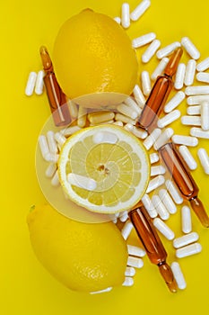 Flying vitamin C pills and lemons cut set on a yellow background.Lots of pills and citrus fruits..Natural Fruit Vitamin