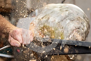 Flying wooden sawdust shavings while creating timber bowl