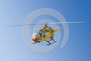 Flying yellow rescue helicopter