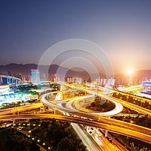 Flyover in modern city with sunset photo