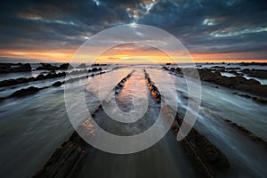 Flysch rocks in barrika beach at sunset