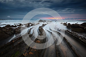 Flysch rocks in barrika beach at sunset