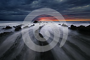 Flysch rocks in barrika beach at sunset