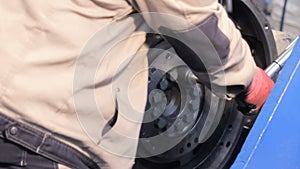 Flywheel of the engine truck. employee works with a torque wrench. tighten the bolts with a torque wrench