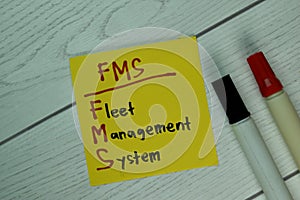 FMS - Fleet Management System write on sticky notes isolated on Wooden Table photo