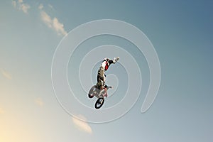 FMX biker jumping on a background of the sky