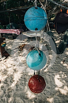 Foam ball buoy for fishing net float hanging on tree under bright sunny day