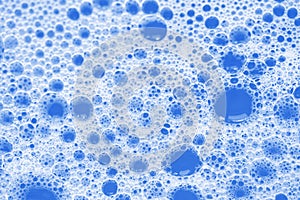 Foam bubbles abstract blue background. Macro shot