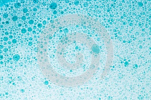 foam bubbles.Blue water with white foam bubbles.Cleanliness and hygiene background. Foam Soap Suds.Texture Foam. blue