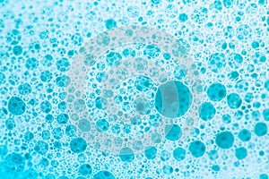 foam bubbles.Blue water with white foam bubbles.Cleanliness and hygiene background. Foam Soap Suds.Texture Foam Close-up