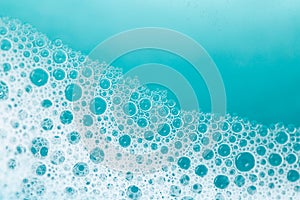 foam bubbles.Blue water with white foam bubbles.Foam Water Soap Suds.Texture Foam . blue bubbles background.