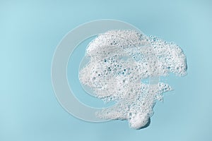 Foam with bubbles. Soap sud on blue background. photo