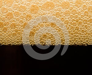 Foam from dark beer with bubbles