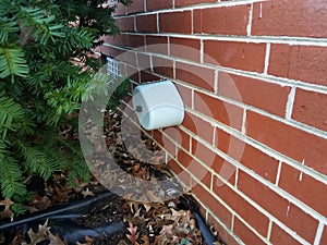 Foam insulation on water spigot with brick wall
