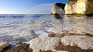 The foam of the ocean on the beach