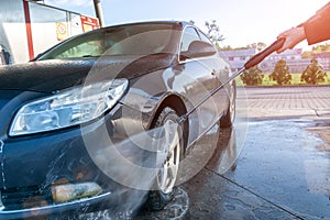 Foam water clean auto car on carwash hand service. Vehicle wash soap, foam on cleaner station. Care with pressure wax.