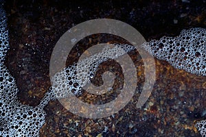 Foam on the water. Dark water