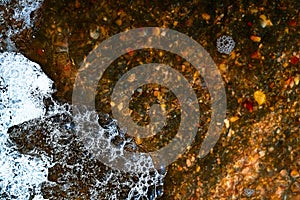 Foam on the water. Dark water